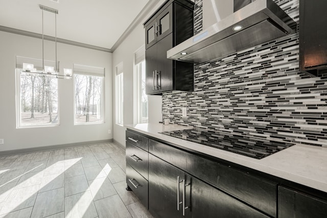 kitchen featuring decorative light fixtures, wall chimney exhaust hood, ornamental molding, decorative backsplash, and black electric stovetop