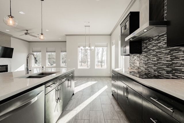 kitchen featuring pendant lighting, dishwasher, wall chimney exhaust hood, and sink