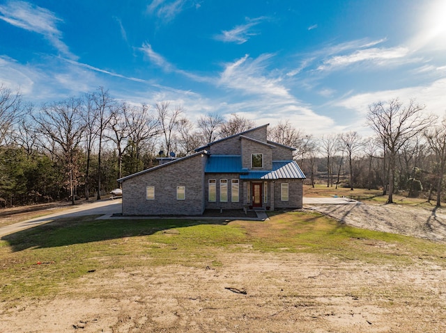 view of side of home with a yard