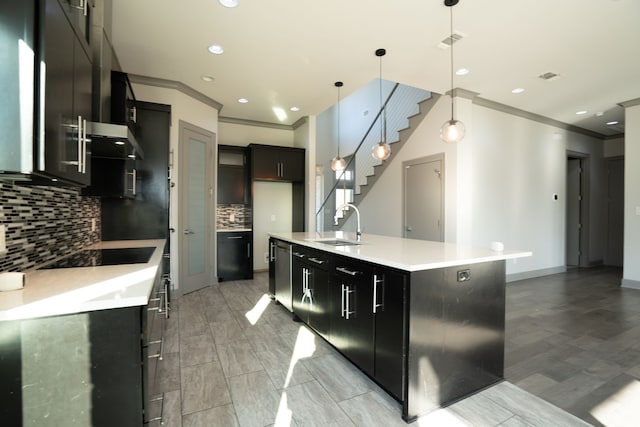 kitchen with dishwasher, hanging light fixtures, an island with sink, tasteful backsplash, and black electric stovetop