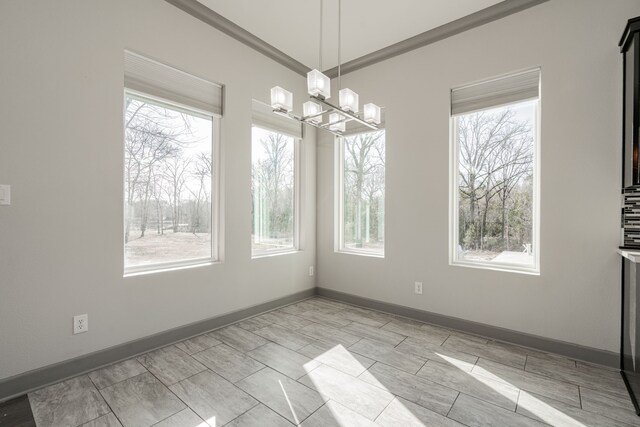 unfurnished dining area featuring a chandelier