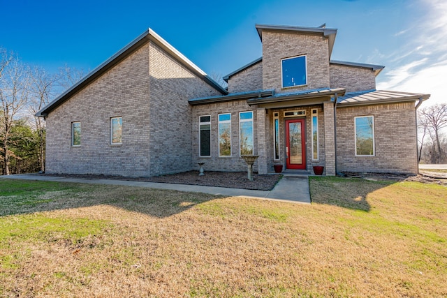 rear view of property with a lawn