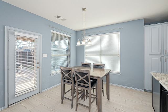 tiled dining room featuring an inviting chandelier