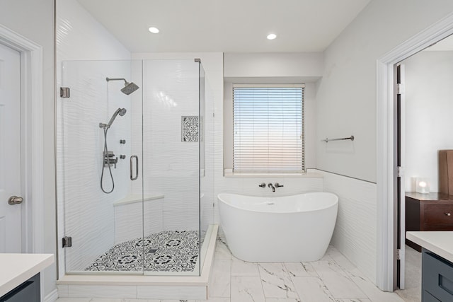 bathroom featuring plus walk in shower and vanity