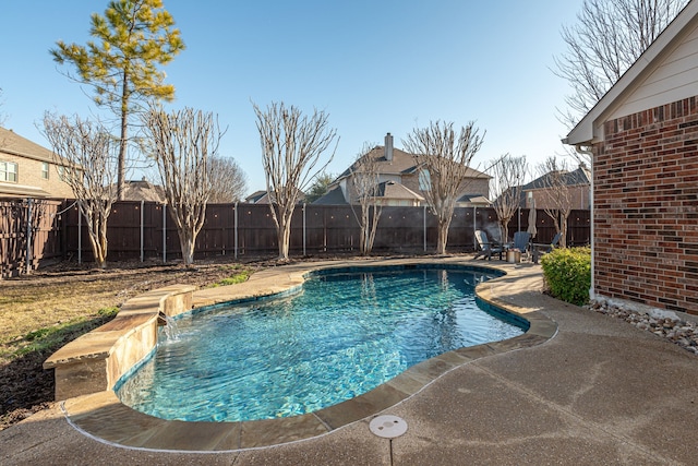 view of swimming pool with pool water feature and a patio