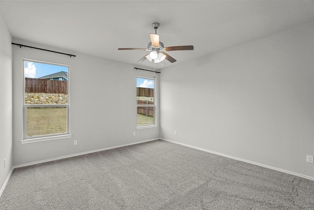 spare room with carpet floors and ceiling fan