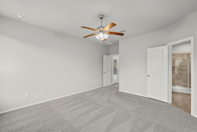 unfurnished bedroom featuring carpet, ceiling fan, and ensuite bathroom