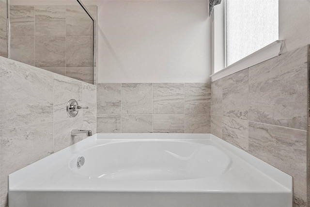 bathroom with a tub to relax in