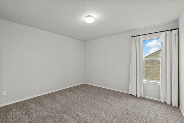 unfurnished room featuring light colored carpet