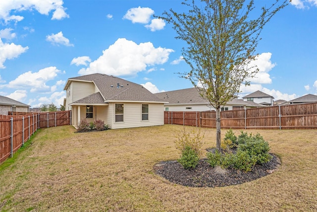 rear view of property featuring a lawn