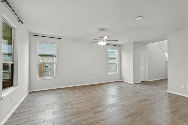 unfurnished room featuring ceiling fan and light wood-type flooring