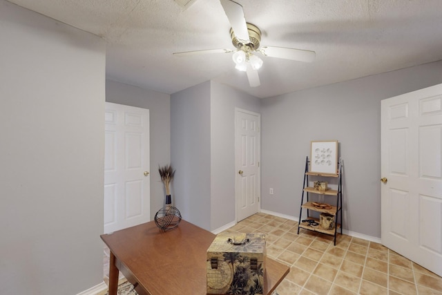 office area with a textured ceiling and ceiling fan