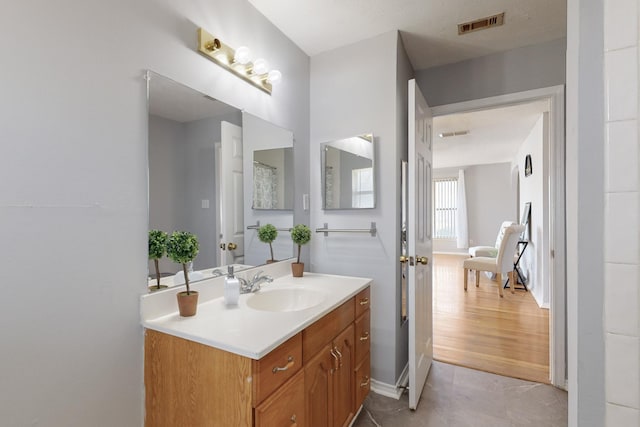 bathroom with tile patterned flooring and vanity