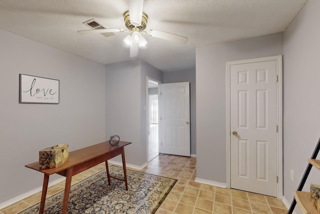 office space with a textured ceiling and ceiling fan