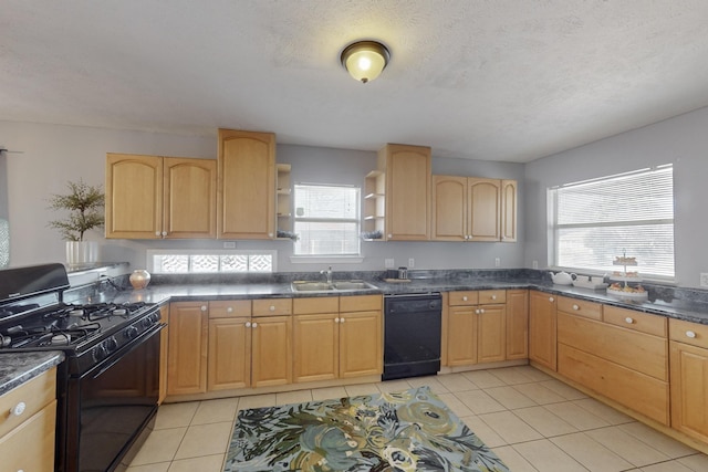 kitchen with a textured ceiling, light brown cabinetry, sink, and black appliances