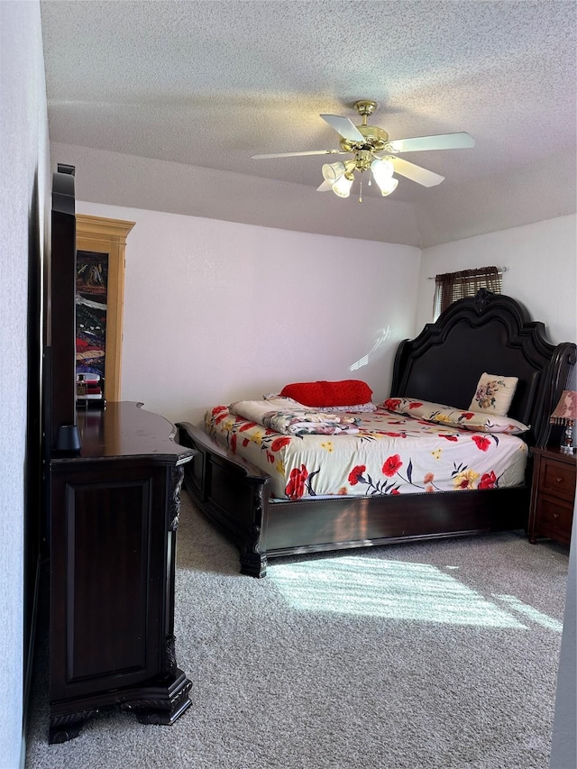 bedroom with a textured ceiling, ceiling fan, and carpet