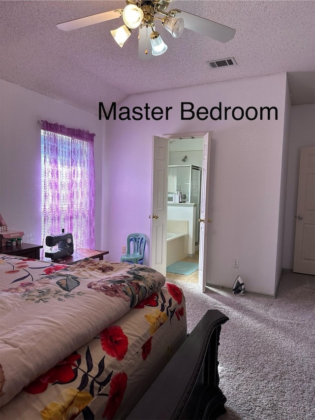 carpeted bedroom with a textured ceiling, ceiling fan, and vaulted ceiling