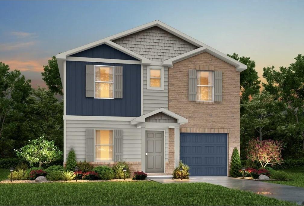 view of front of home featuring a yard and a garage