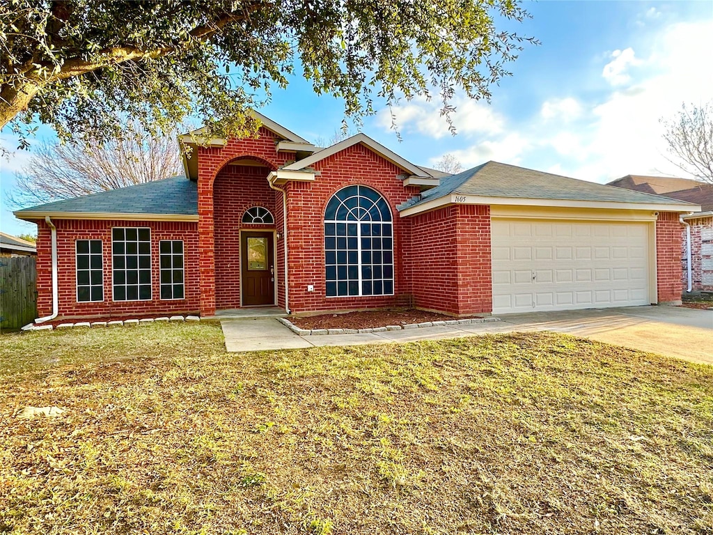 view of front property with a garage and a front lawn