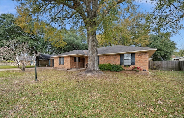 ranch-style home featuring a front yard