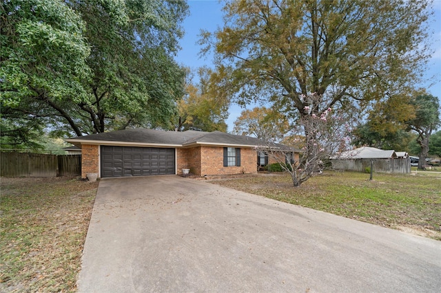 ranch-style house featuring a garage and a front lawn