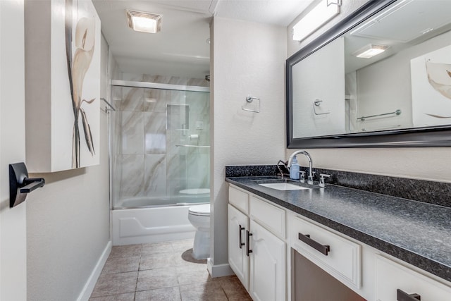 full bathroom featuring tile patterned flooring, vanity, toilet, and bath / shower combo with glass door