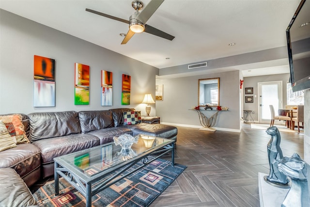 living room with ceiling fan and dark parquet floors