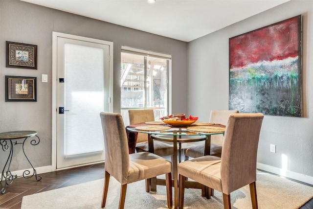 dining room with parquet flooring