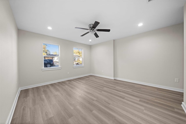 unfurnished room with ceiling fan and light hardwood / wood-style flooring