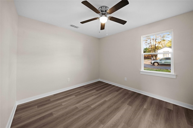 unfurnished room with ceiling fan and dark wood-type flooring