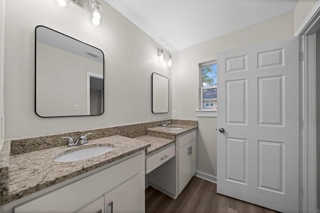 bathroom with hardwood / wood-style floors and vanity