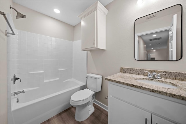 full bathroom with washtub / shower combination, toilet, wood-type flooring, and vanity