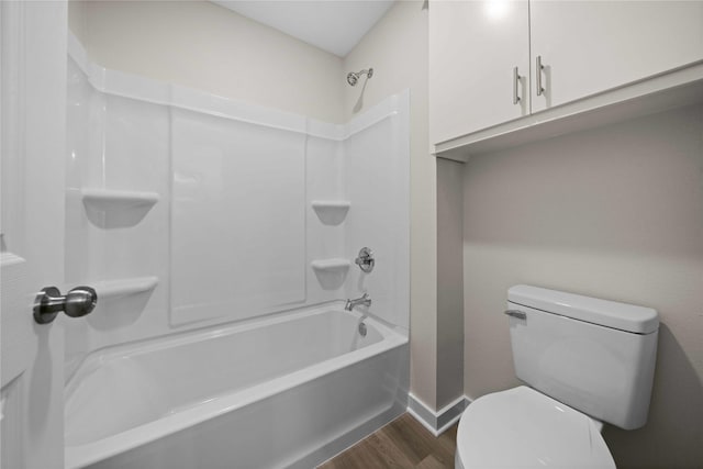 bathroom featuring wood-type flooring,  shower combination, and toilet