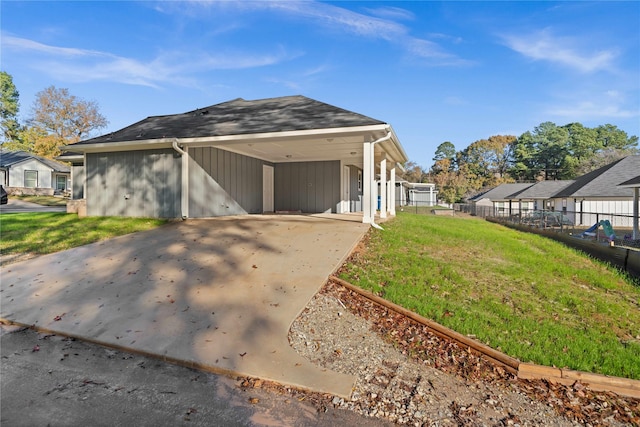 view of front facade with a front yard and a carport