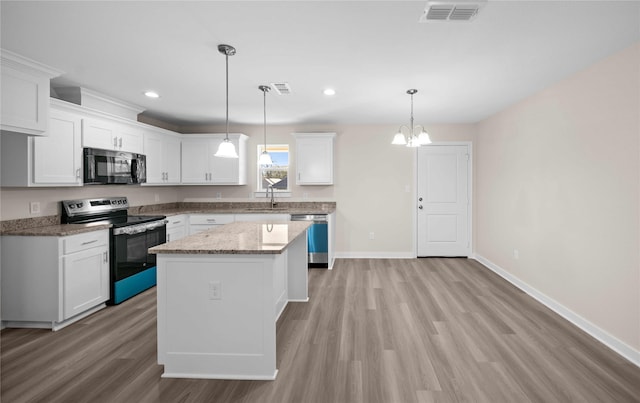 kitchen featuring white cabinets, a kitchen island, stainless steel appliances, and pendant lighting