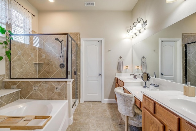 bathroom with vanity and independent shower and bath