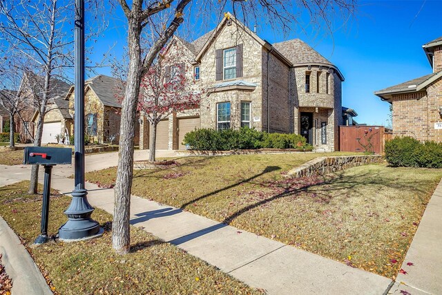 view of front of house featuring a garage and a front yard