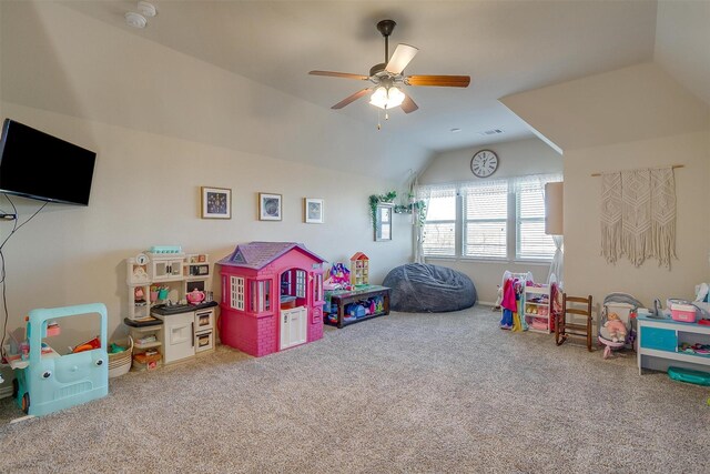 rec room with carpet flooring, ceiling fan, and vaulted ceiling