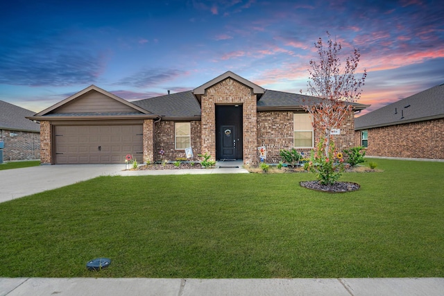 ranch-style home featuring a yard and a garage