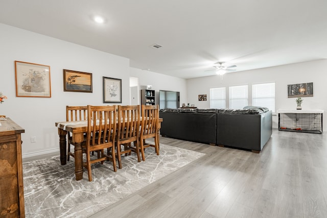 dining room with hardwood / wood-style floors and ceiling fan