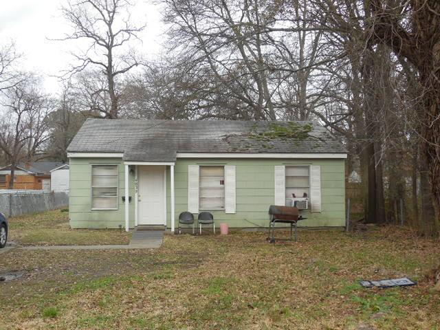 bungalow-style home with a front lawn