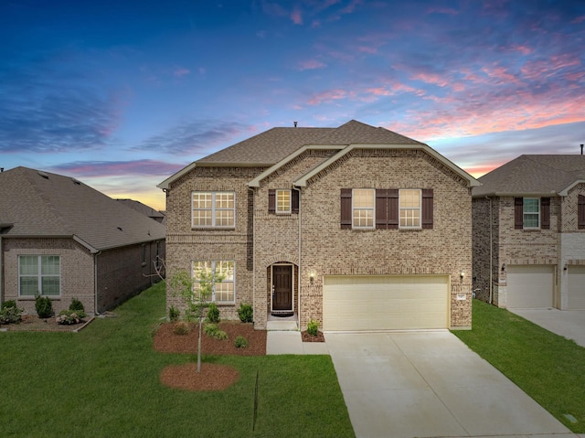 view of front of home featuring a garage and a yard