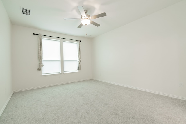 unfurnished room featuring light carpet and ceiling fan