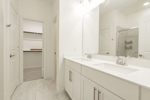 bathroom featuring vanity, tile patterned floors, and an enclosed shower