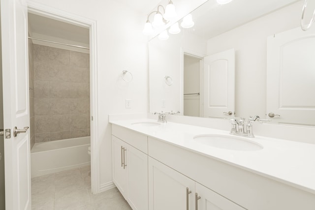 full bathroom with tiled shower / bath, tile patterned floors, vanity, and toilet