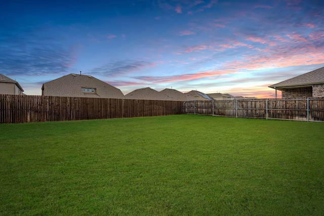 view of yard at dusk