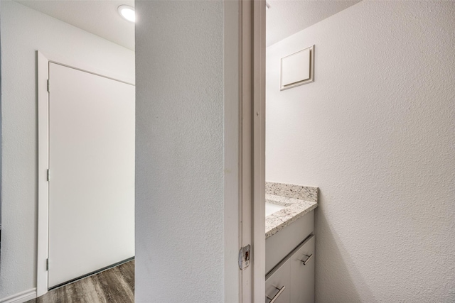 bathroom with hardwood / wood-style floors and vanity