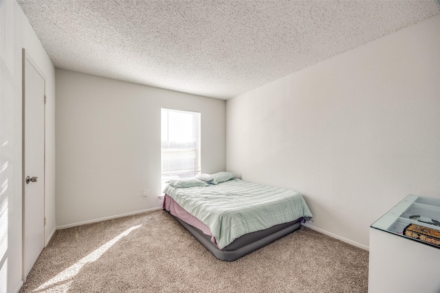 carpeted bedroom featuring a textured ceiling