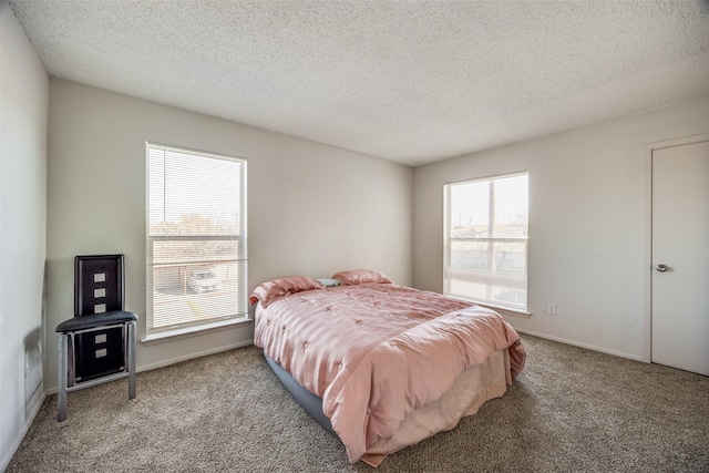 bedroom with carpet floors and a textured ceiling