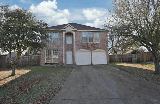 view of front facade with a garage and a front lawn